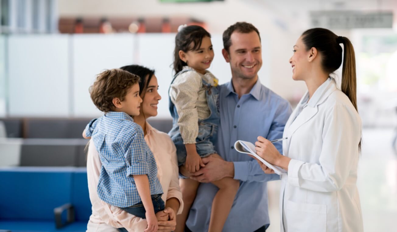 A doctor speaking with a family with two children
